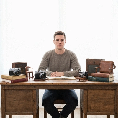 Person researching market trends on a laptop with various items in the background